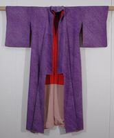 Purple silk crepe with hitta miura and hand tie-dyed design achieving the effect of many diagonal rows of tiny squares.  Upper lining is plain weave momi (red silk) and lower and cuff linings are mauve pink.