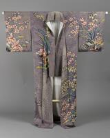 <p>Lavender and white chirimen Houmongi kimono with rouketsu dyed scale patterns and tegaki (hand-painted) white, red, pale blue and green floral patterning with metallic contour embroidery with a purple and white gradated lining? The kimono has elongated sleeves and one kamon (family crest) on the back neck.</p>

