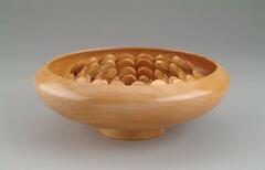 wood vessel containing half-circles of wood arranged in central concentric rings