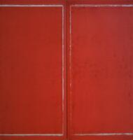 Two large panels painted red panels of aluminum, situated against one another so that the seam is visible at center. A line of white runs along each panel's outer edge.