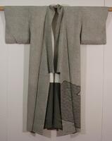Gray-green silk with tie-dye design in hitta kanoko technique.  The bottom is decorated with a shibori wave pattern.  Lining is plain weave white silk above; white at top, gray at bottom and sleeve ends.