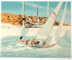 A hyper-realistic image of a sailboat with a full crew in a sink filled with water. The sail boat has an american flag on the back. In the background, behind the sink, is a formation of desert cliffs.