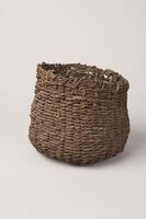 A wide cylindrically-shaped basket with an opening at the top. Used to store seeds while farmers would walk and scatter them to plant.<br />
<br />
This seed pouch is made by weaving double strips of Korean moonseed, following the method of weaving a straw mat. It was used to store seeds or when plating them.
<p>[Korean Collection, University of Michigan Museum of Art (2017) p. 277]</p>
