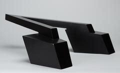 Abstract sculpture consisting of three components, which give the appearance of a black &#39;V&#39; and two rectangular boxes at each leg of the &#39;V&#39;.