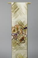 <p>Beige fukuro (single-sided) Obi with interwoven gold brushstroke wickerwork patterning with embroidered red, orange, green, white and violet phoenix-peacock hybrid, dragon, clouds, and paulownia leaf motifs arranged in hachiryoumon (eight-petalled, pointed flowers) and hand-drum motifs.</p>
