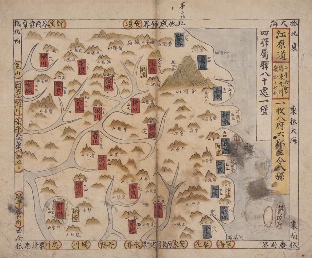 A woodcut print map depicting the province of Gangwon-do. Various offices and units are parked with red and blue rectangular cartouches. There is also writing along the entire map border, and to the right of the print are names written in yellow boxes. Rivers and the sea are depicted in light blue while the mountains and typically generic three-peak formations. One mountain in particular stands out due to its height and detail near the upper right side of the map.<br />
<br />
This woodcut print map depicts the province of Gangwon-do, with twenty-six gwan (官; administrative offices) governing nine ju (州; administrative units) in the Yeongdong region (嶺東; the part of Gangwon-do that lies to the east of Daegwallyeong Pass) and seventeen ju in the Yeongseo region (嶺西; the part of the province to the west of the pass) in the nineteenth century. The names of the nine j u in the Yeongdong region are handwritten in ink in blue rectangular cartouches while those of the seventeen in the Yeongseo region are labeled u