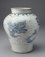 Large porcelain jar decorated with cobalt pigment under colorless glaze. Repeating clouds border the rim of the jar, while a dragon head and feet are depicted on the main body below. Two blue bands separate the design from the white base below, balancing the rim and bottom portion of the jar. The very tip and base of the piece are also marked with blue bands.<br />
<br />
This is a blue-and-white jar with cloud and dragon designs which is tought to have been produced at Bunwon-ri, Gwangju-si, Gyeonggi-do around the year1883, when official court kilns there were privatized. The dragon is painted with cobalt on a large jar, but with only its head fully exposed and the body largely concealed by white clouds. This distinctive design is rarely found in blue-and-white porcelain. Two blue horizontal lines encircle the rim, while its shoulder features a yeoui-head band. It is glazed all the way down to the outer base, and coarse sand was used as kiln spurs, which leaves its mark on the foot rim. The Chinese charact