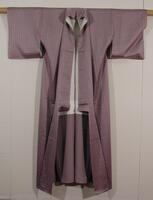 Figured satin weave lavender silk with vertical Hannya shinko text.