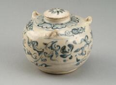 A small, slightly squat, globular stoneware jar, resting on a broad and short foot, with a short, narrow neck rising to hold a slightly domed lid. There are three small lug handles at the shoulder, allowing the jar to be carried by a cord. The jar is decorated with three horizontal zones of decoration, either floral or abstract designs drawn freehand in cobalt blue pigment before a translucent glaze was applied to the entire vessel.