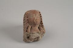 Indian terracotta figure of a woman's head with long hair, craft with facial features