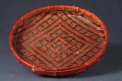 Flat woven bamboo basket with geometric pattern in red and black