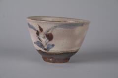 Tea bowl with underglaze floral design.