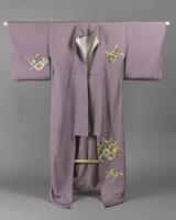 <p>lavender houmongi kimono with interwoven, dyed, and embroidered gold and various blue and orange interlocking circles on the front and back with one kamon (family crest) with a white and lavender inner lining.</p>
