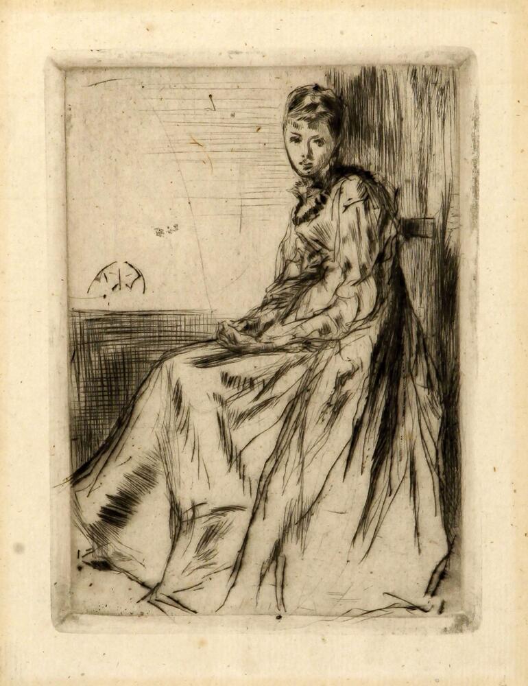 A woman is seen seated in a chair, facing to the left but looking towards the viewer. She is in a long dress with long sleeves. She has her hands in her lap and holds a sheet of paper.