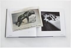 Image of a book lying open to a page featuring a picture of a child lying on a bed. A newsclipping featuring a photo of a statue of a child lies on the book across the open page.  