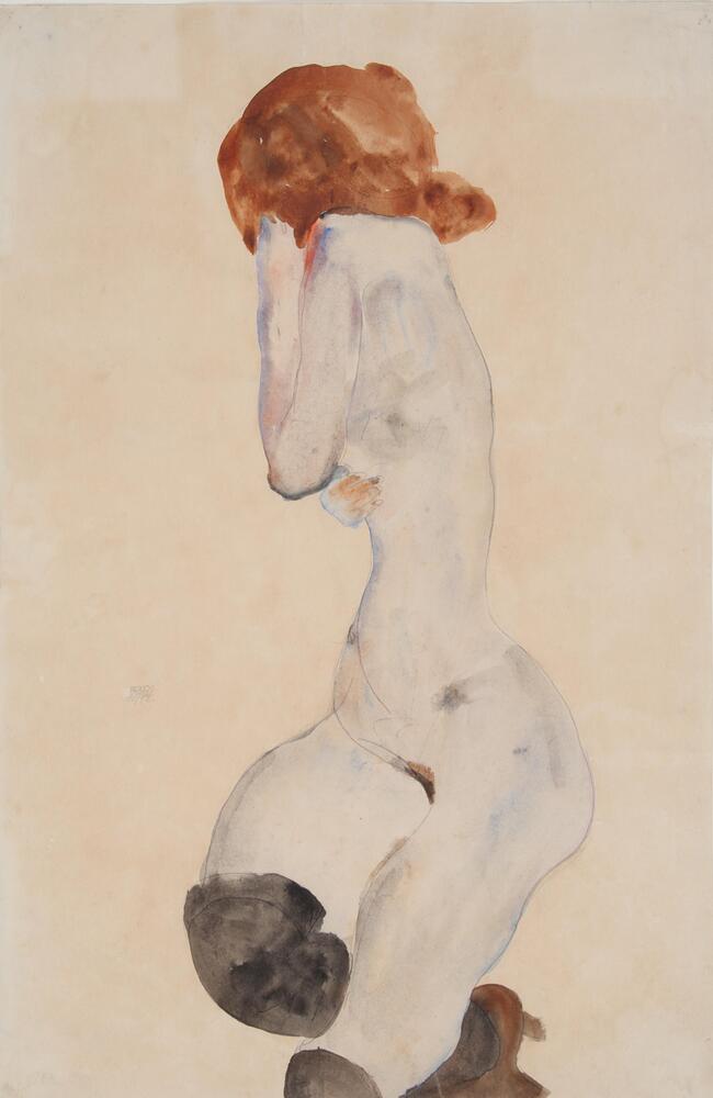 Image of a nude female with black stockings and brown hair. Her lower body is facing the viewer and her upper body is facing away with her hands covering her face.