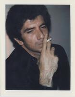 A bust-length portrait of a man. He wears black and holds a cigarette in his mouth, between his fingers.