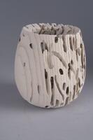 small sandblasted wood vase displaying holes and trails eaten by worms