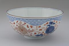 Imari-style bowl with chrysanthemum and other geometric designs with&nbsp;with blue and iron brown underglaze and enamel overglaze painting.