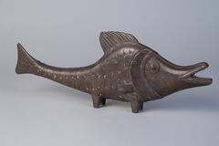Cast brass fish, tail in an upwards arch, mouth open.