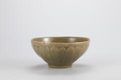 <p>This type of bowls was produced in the 12th century when the production of celadon was increased. is piece is assumed to be a product of a kiln in Sadang-ri, Gangjin-gun, Jeollanam-do. e outer wall is decorated with incised and raised deisgn of a two- tiered lotus petal. The bowl was entirely glazed including the rim of the foot. e outer base retains three white quartzite spur marks. e glaze is fused well, displaying a ne gloss, but parts of it have been oxidized to tinge the inner surface with yellow.<br />
[<em>Korean Collection, University of Michigan Museum of Art </em>(2014) p.102]</p>
