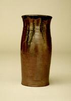 Cylindrical vessel with striated glaze. The rings of the thrown clay can be seen beneath the glaze.