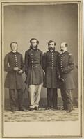 Full-length, standing portrait of four men in military uniforms. 