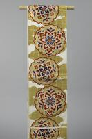 <p>white fukuro (single-sided) obi with gold tiled clouds and yukiwa (petaled snowflake) motifs containing various gradated red, white,orange, blue, and violet karahana (stylized Chinese floral motifs).</p>
