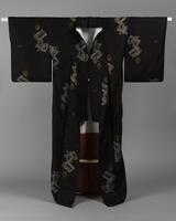 <p>dark brown komon tsumugi kimono with interwoven gold coins, gray books, red tie strings, and hand drum patterning with a red and white inner lining.</p>
