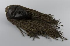 Mask with wooden face and raffia hair