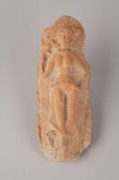 Indian terracotta sculpture of a naked woman laying down and facing forward.