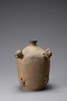 Unglazed gray stoneware flattened bottle with two lion-head lugs near teh upper corners, and two turtle shaped lugs on the bottom.