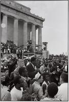 A group of people marching in protest outside of the Lincoln Memorial in Washington, D.C.